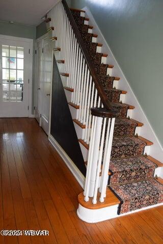 stairway featuring hardwood / wood-style floors