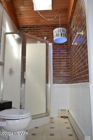 bathroom with wooden ceiling, a shower with door, tile patterned floors, toilet, and brick wall