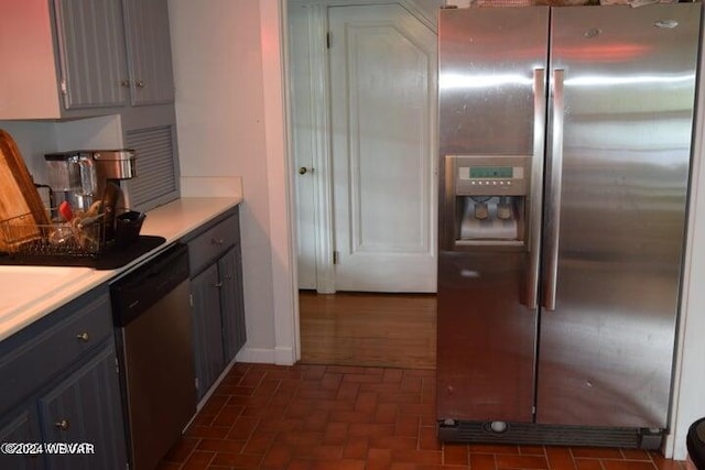 kitchen with gray cabinets and stainless steel appliances