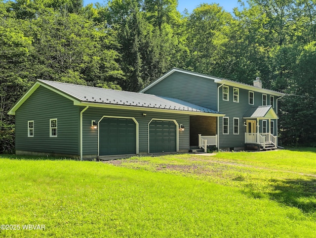 450 Rock Ledge Rd, Laporte, PA 18626 - view of front of property with a chimney, a metal roof, an attached garage, a front lawn, and driveway