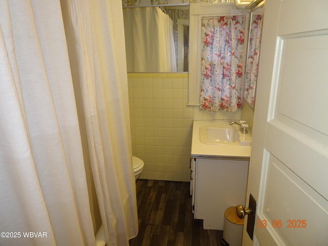 full bathroom with toilet, vanity, tile walls, and wood finished floors