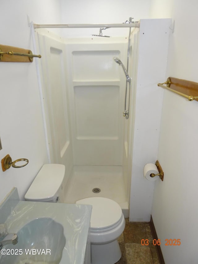 full bathroom with a stall shower, tile patterned flooring, vanity, and toilet