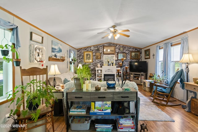 394 Rte 973, Cogan Station, PA 17728 - living area with ornamental molding, vaulted ceiling, ceiling fan, wood finished floors, and a fireplace