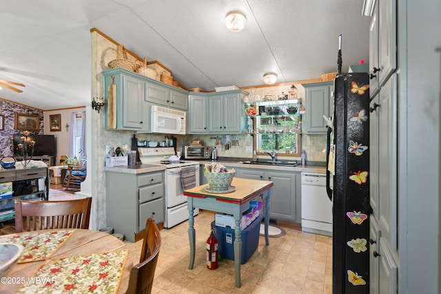 394 Rte 973, Cogan Station, PA 17728 - kitchen with white appliances, vaulted ceiling, a sink, light countertops, and ceiling fan