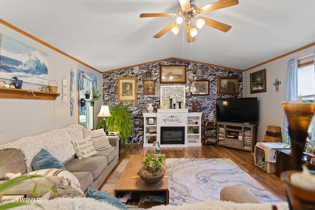 394 Rte 973, Cogan Station, PA 17728 - living area with crown molding, wood finished floors, a glass covered fireplace, vaulted ceiling, and a ceiling fan
