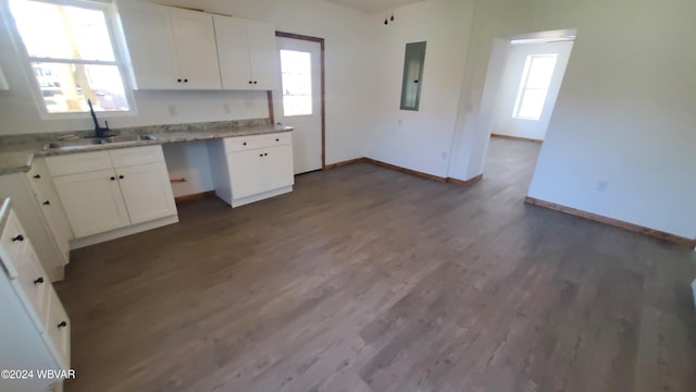 kitchen featuring a healthy amount of sunlight, white cabinetry, and sink