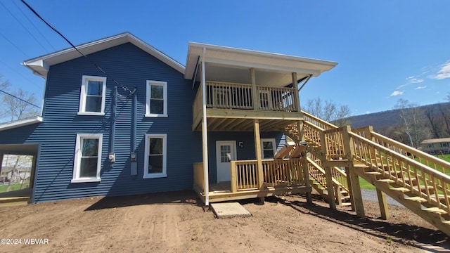 rear view of property with a balcony