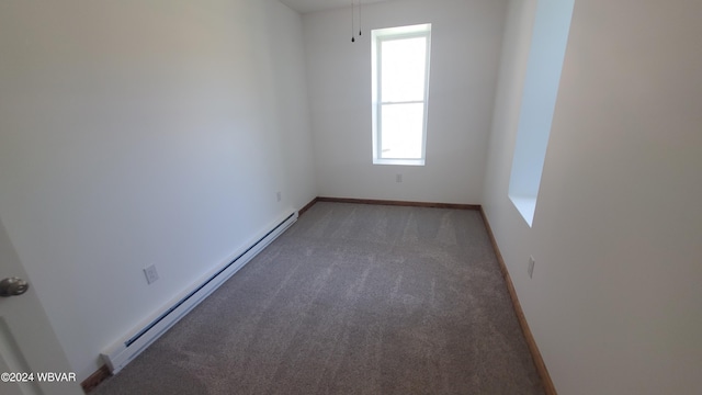 carpeted empty room with a baseboard heating unit