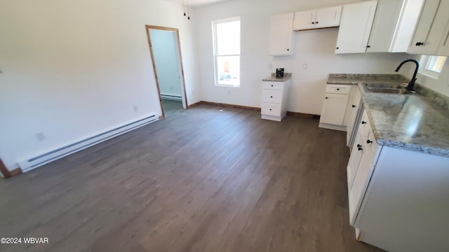 kitchen with white cabinetry, sink, plenty of natural light, and a baseboard heating unit