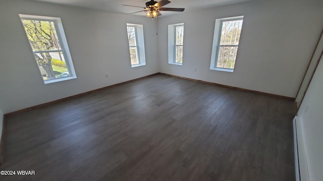 spare room with dark hardwood / wood-style floors and ceiling fan