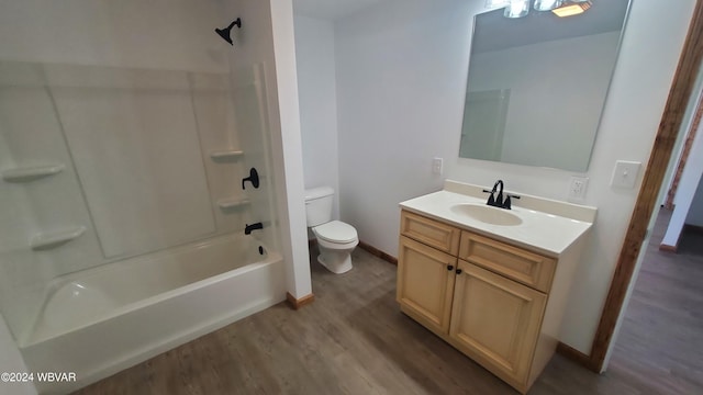 full bathroom featuring hardwood / wood-style floors, vanity, toilet, and shower / washtub combination