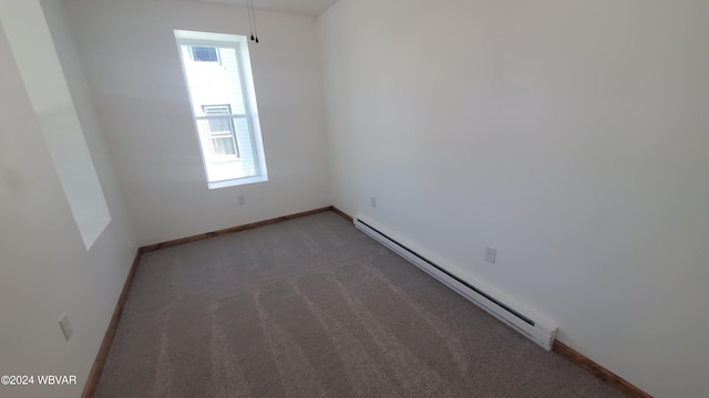 empty room with a baseboard radiator and dark carpet