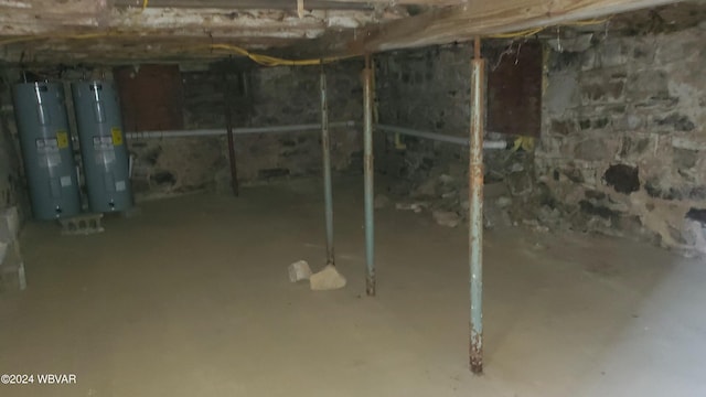 basement featuring gas water heater and water heater