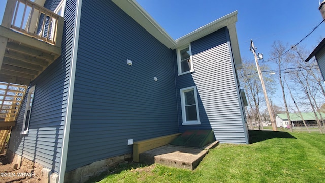 view of property exterior featuring a lawn