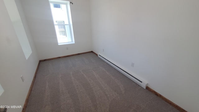 carpeted spare room featuring a baseboard radiator