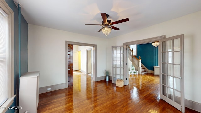 665 5th Ave, Williamsport, PA 17701 - empty room featuring ceiling fan, stairway, wood finished floors, french doors, and baseboards