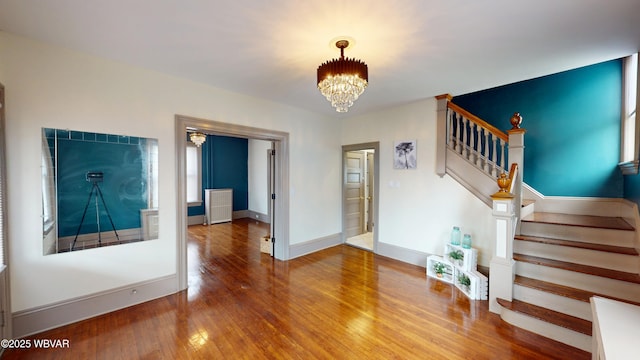 665 5th Ave, Williamsport, PA 17701 - interior space featuring a chandelier, stairway, hardwood / wood-style flooring, and baseboards