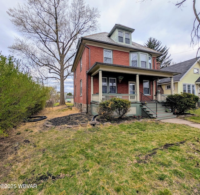 665 5th Ave, Williamsport, PA 17701 - traditional style home with brick siding, a front yard, and a porch