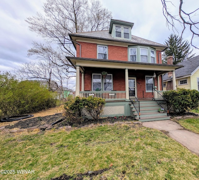 665 5th Ave, Williamsport, PA 17701 - traditional style home with a porch, brick siding, and a front lawn