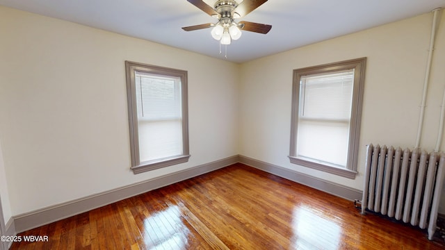 665 5th Ave, Williamsport, PA 17701 - spare room with radiator heating unit, baseboards, hardwood / wood-style floors, and a healthy amount of sunlight