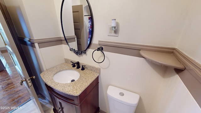 665 5th Ave, Williamsport, PA 17701 - bathroom with vanity, toilet, and wood finished floors