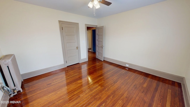 665 5th Ave, Williamsport, PA 17701 - unfurnished bedroom with baseboards, radiator, and hardwood / wood-style flooring