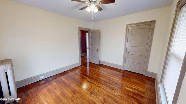 665 5th Ave, Williamsport, PA 17701 - unfurnished bedroom with baseboards, radiator, ceiling fan, and hardwood / wood-style flooring