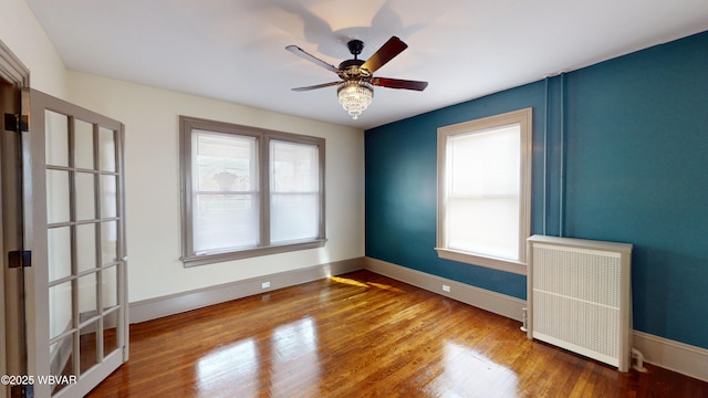 665 5th Ave, Williamsport, PA 17701 - empty room featuring baseboards, a ceiling fan, radiator, and wood finished floors