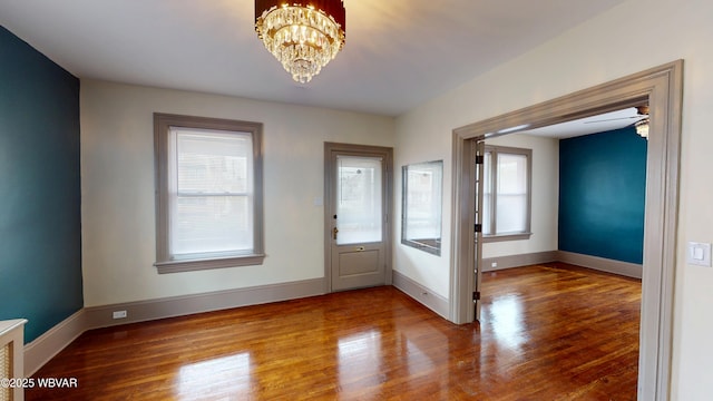 665 5th Ave, Williamsport, PA 17701 - interior space with a healthy amount of sunlight, wood finished floors, a notable chandelier, and baseboards