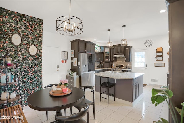 dining room featuring light tile patterned floors and sink