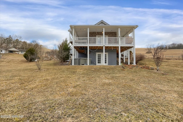 rear view of property featuring a yard and a wooden deck