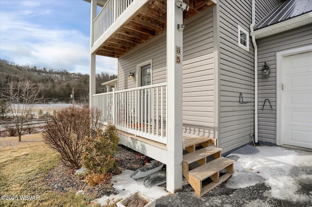 property entrance featuring a garage and a balcony