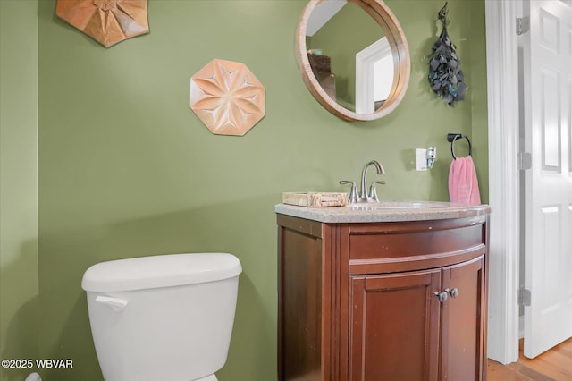 bathroom featuring toilet and vanity