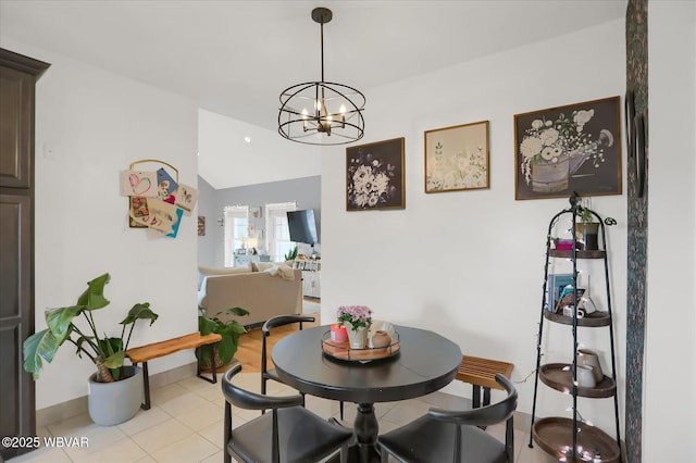 dining space with an inviting chandelier, vaulted ceiling, and light tile patterned floors