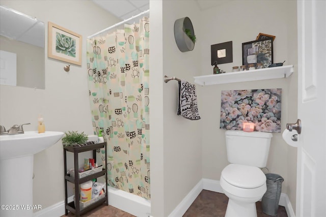 bathroom with sink, toilet, and walk in shower