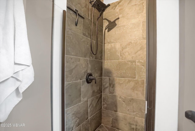 bathroom with tiled shower