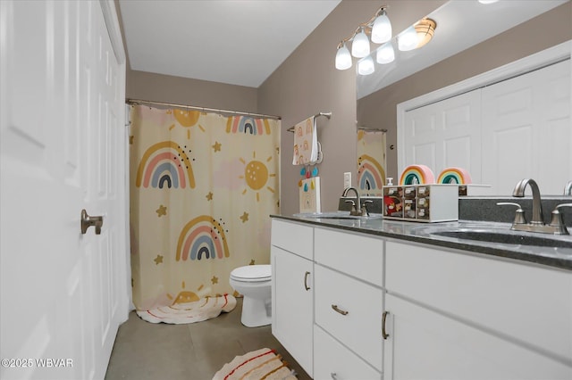 bathroom featuring toilet, vanity, tile patterned flooring, and a shower with shower curtain