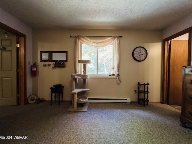 miscellaneous room with a textured ceiling, carpet floors, and a baseboard radiator