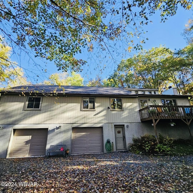 multi unit property featuring a deck and a garage