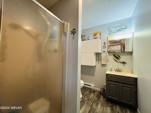 bathroom featuring a baseboard radiator, wood-type flooring, toilet, a shower with door, and vanity