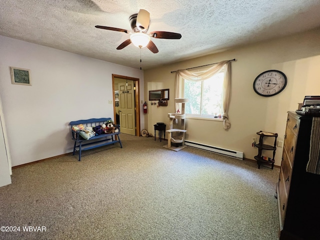 living area with ceiling fan, carpet, a textured ceiling, and a baseboard heating unit