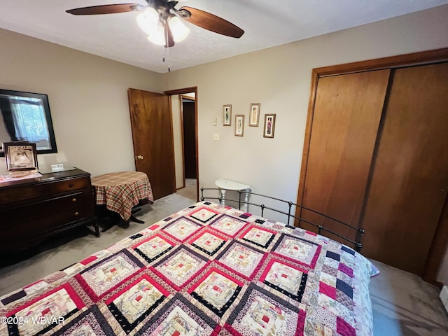 carpeted bedroom featuring a closet and ceiling fan