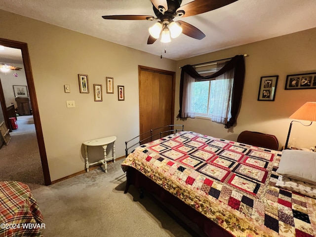 bedroom featuring ceiling fan, light carpet, and a closet