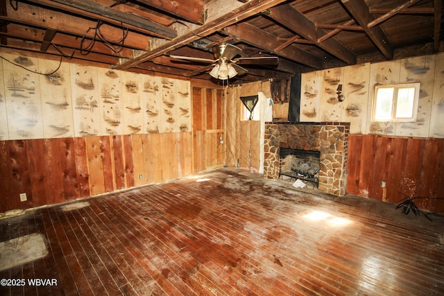 486 Mcintyre Way, Cogan Station, PA 17728 - unfurnished living room with wooden walls, hardwood / wood-style flooring, ceiling fan, and a stone fireplace