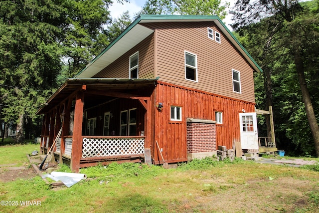 486 Mcintyre Way, Cogan Station, PA 17728 - view of property exterior with board and batten siding, a yard, and entry steps