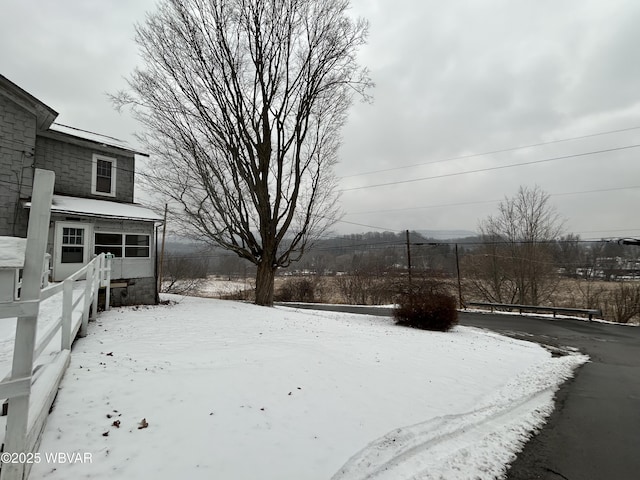 view of yard layered in snow