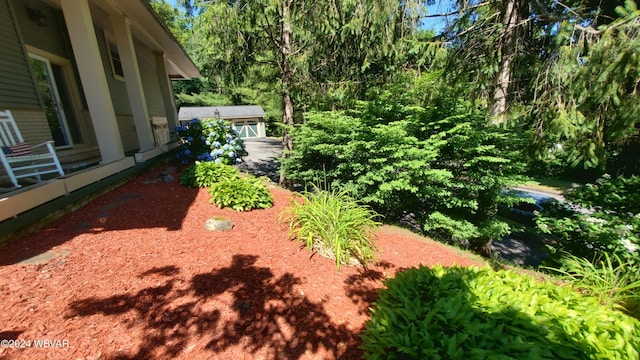 view of yard featuring an outbuilding and a garage