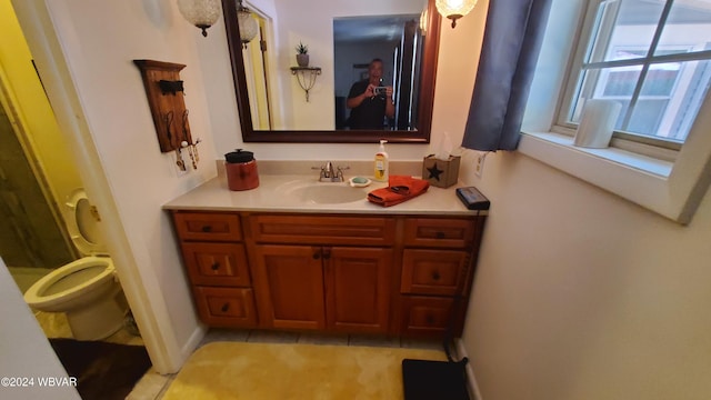 bathroom featuring vanity, toilet, and tile patterned flooring