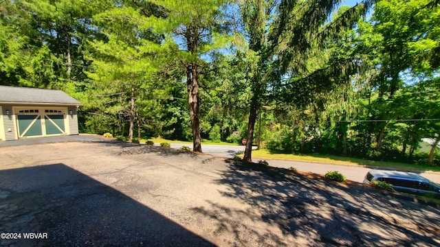 view of yard featuring a garage and an outdoor structure