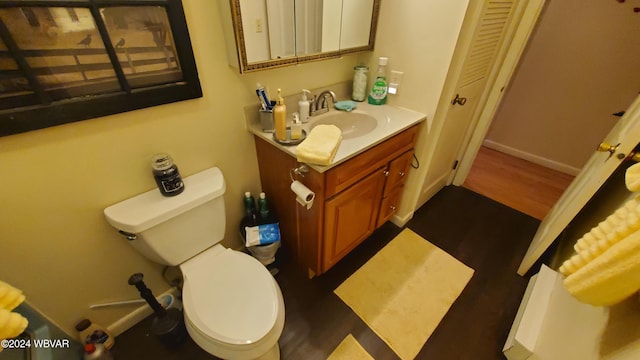 bathroom featuring hardwood / wood-style flooring, vanity, and toilet